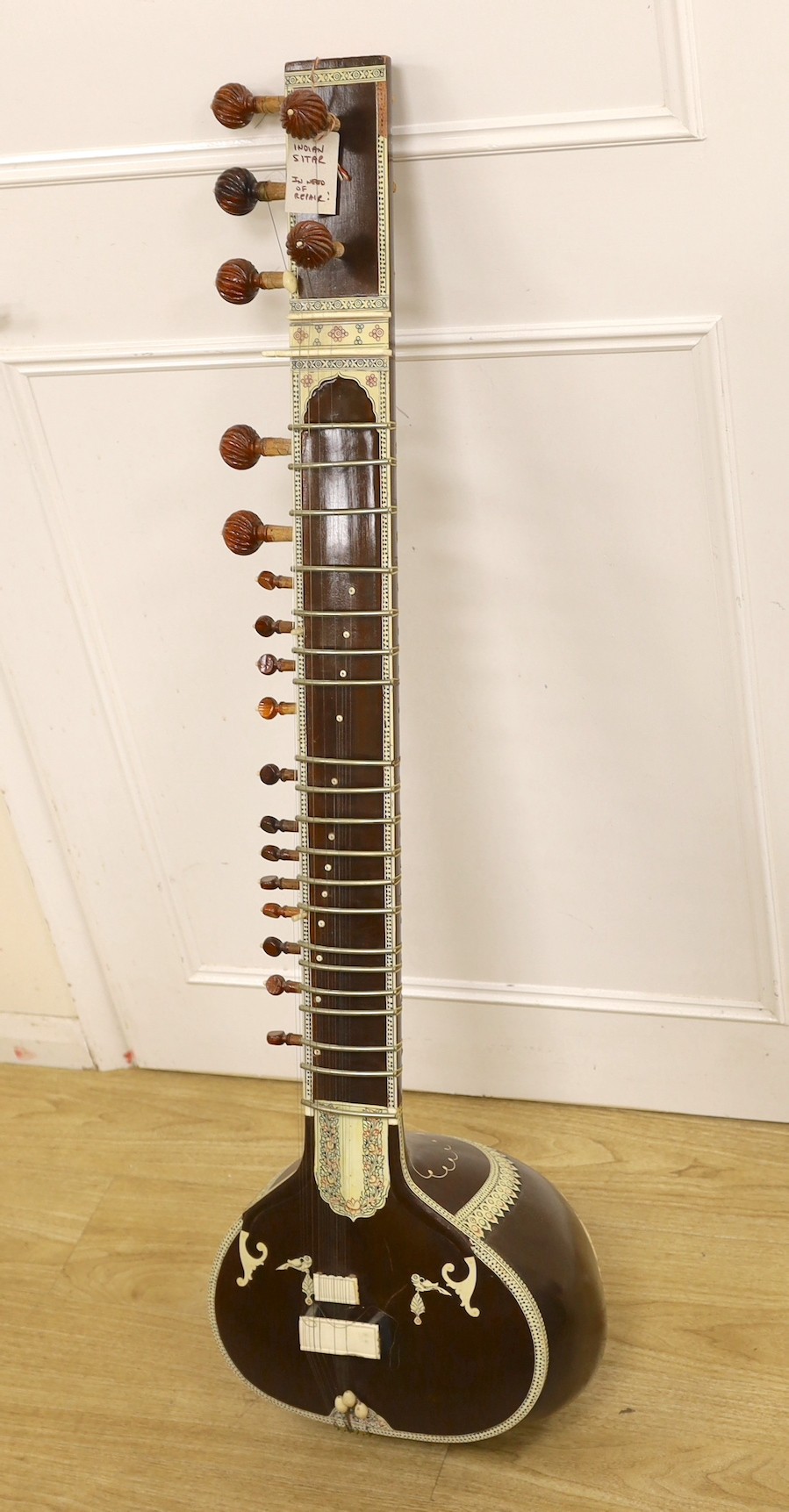 An Indian Sitar (in need of repair) with hard case, 123cms high.